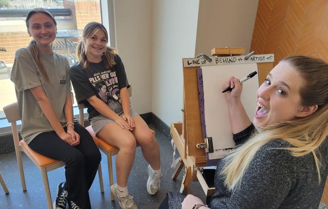 Artist Ariana draws a couple students at University of Tennesse Knoxville